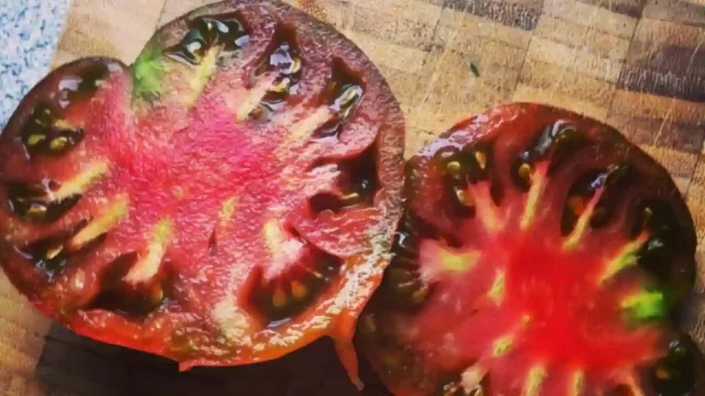 The black krim tomato half cut with seeds